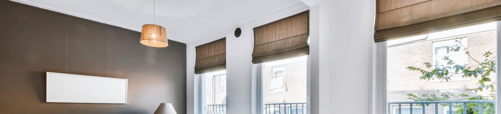 Close-up of dark roman shades for bedroom windows, highlighting the sleek design and premium fabric