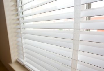 Faux wood blinds with wood grain finish, enhancing your interior decor.