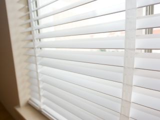 Faux wood blinds with wood grain finish, enhancing your interior decor.