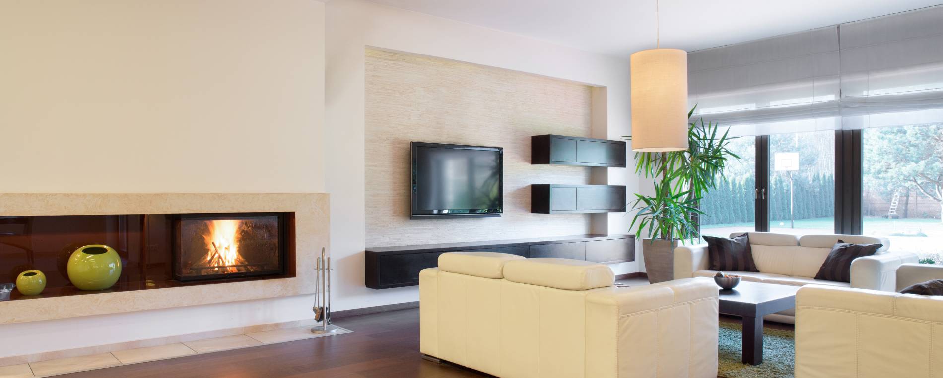 A view at a bright cozy living room with sheer Roman shades